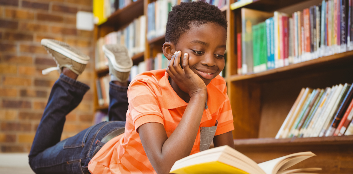 young black boy reading a book